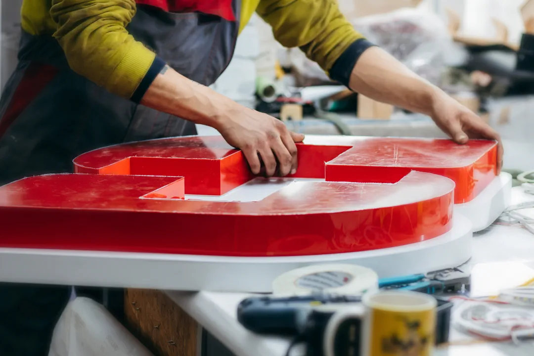sign maker installing custom indoor sign